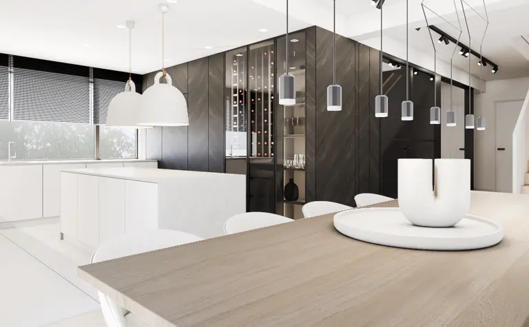 Wnętrze kuchni w stylu minimalistycznym z białymi meblami i czarnymi detalami.