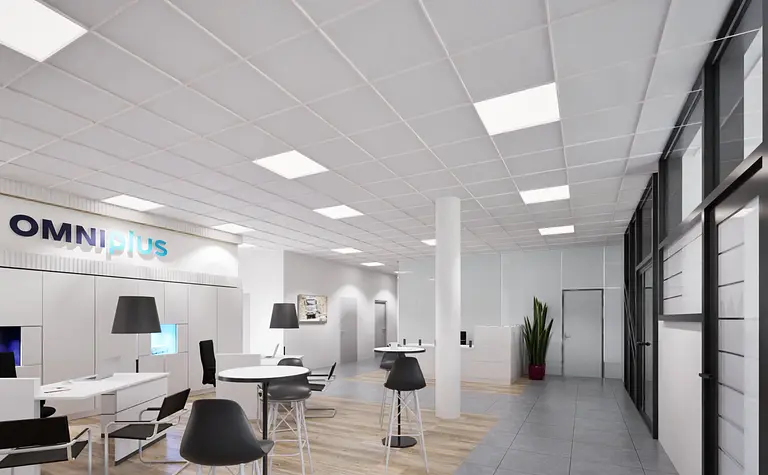 Wnętrze biura z industrialnymi i nowoczesnymi elementami, białe meble, szare podłogi.