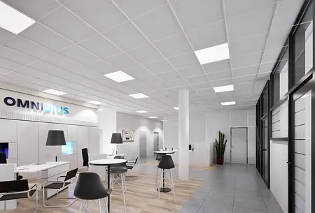 Wnętrze biura z industrialnymi i nowoczesnymi elementami, białe meble, szare podłogi.