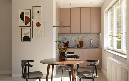Wnętrze kuchni w stylu soft minimalizm i vintage z różowymi meblami i drewnianym blatem.