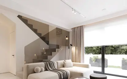 Nowoczesny salon z minimalistycznym wystrojem i dużym oknem.