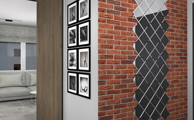 Wnętrze z ceglaną ścianą, szarymi meblami i nowoczesnymi detalami w stylu art deco, boho, industrialnym.