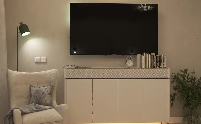 Wnętrze salonu z telewizorem, jasnymi meblami i rośliną, styl nowoczesny i skandynawski.