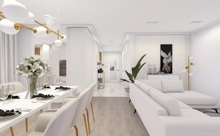 Wnętrze salonu z białą sofą, eleganckim oświetleniem i roślinami.