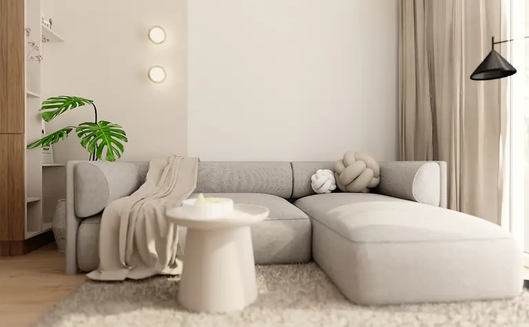 Wnętrze salonu w stylu japandi i minimalistycznym z szarym narożnikiem.