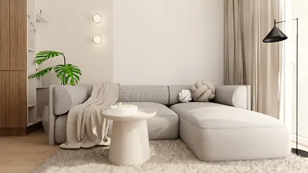 Wnętrze salonu w stylu japandi i minimalistycznym z szarym narożnikiem.