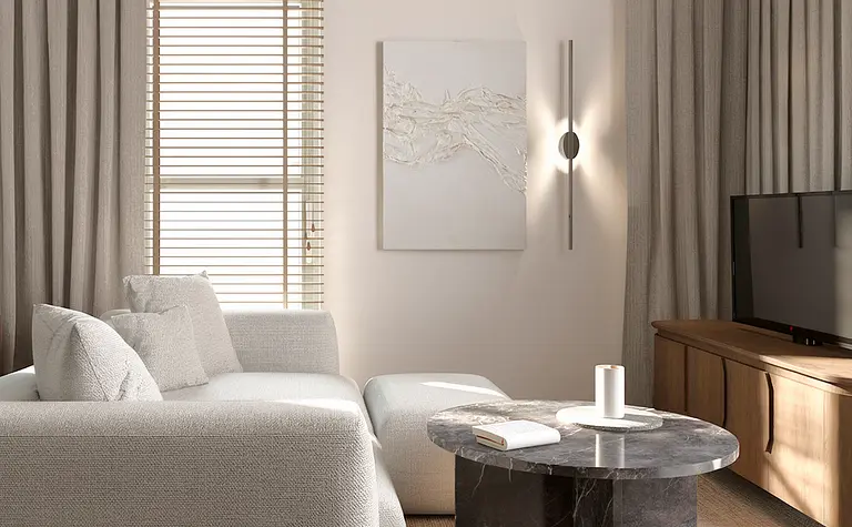 Nowoczesny salon w stylu minimalistycznym z szarymi meblami i czarnym stolikiem.