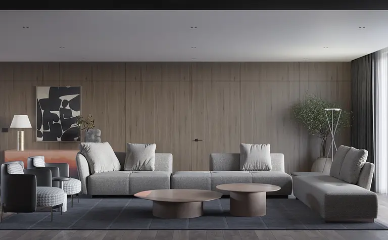 Wnętrze minimalistycznego salonu z szarymi kanapami i drewnianymi elementami.