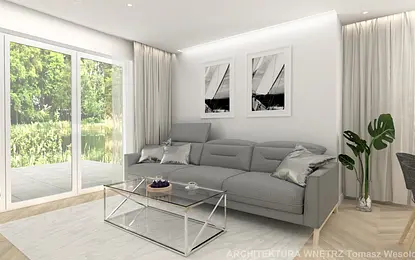 Nowoczesny salon z szarym narożnikiem, szklanym stolikiem i roślinami, minimalistyczny design.