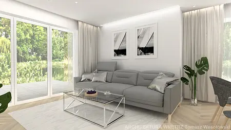 Nowoczesny salon z szarym narożnikiem, szklanym stolikiem i roślinami, minimalistyczny design.