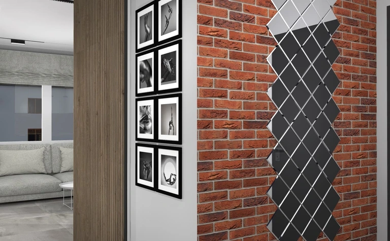 Wnętrze z ceglaną ścianą, szarymi meblami i nowoczesnymi detalami w stylu art deco, boho, industrialnym.