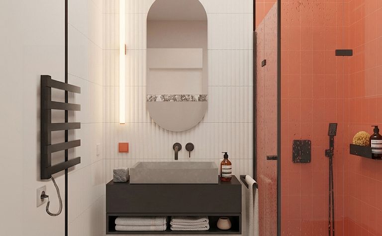 Wnętrze łazienki z industrialnym i minimalistycznym stylem, szarym blatem, pomarańczowymi płytkami.