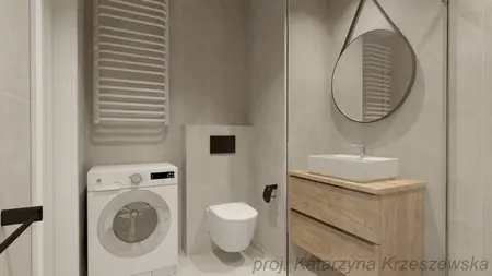 Wnętrze łazienki z pralką, drewnianą szafką i lustrem. Styl industrialny, minimalistyczny, współczesny.