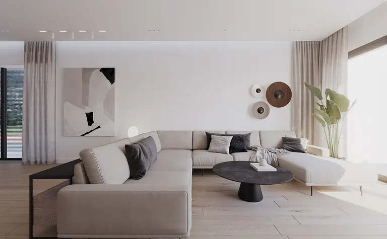Wnętrze salonu w stylu minimalistycznym z jasnymi meblami i rośliną.