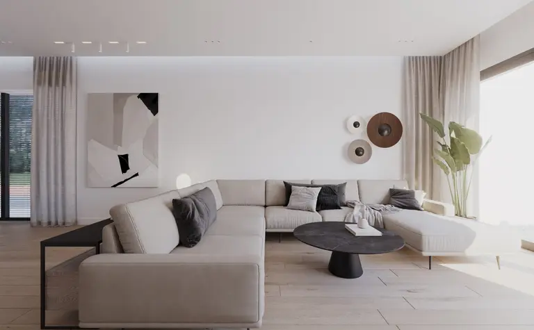 Wnętrze salonu w stylu minimalistycznym z jasnymi meblami i rośliną.
