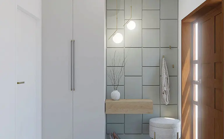 Przedpokój z szarymi płytkami, drewnianymi elementami i minimalistycznym wystrojem w stylu quiet luxury.