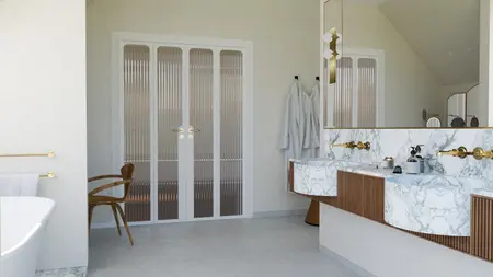 Wnętrze łazienki w stylu art deco z marmurowymi wykończeniami i złotymi detalami.