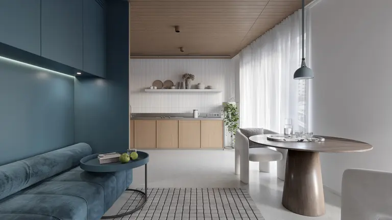 Wnętrze kuchni w stylach boho, japandi i minimalistycznym z niebieską sofą.