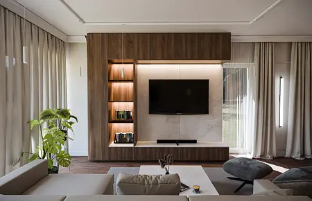 Nowoczesne wnętrze salonu z drewnianymi meblami i szaro-białymi dodatkami.