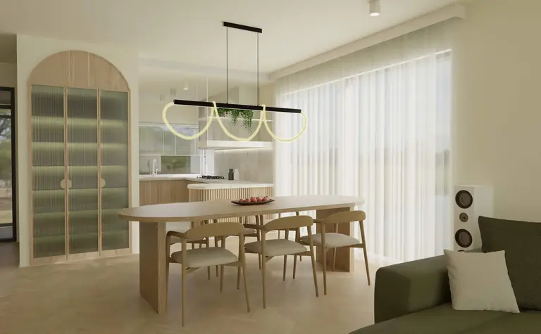 Jasna jadalnia z owalnym stołem drewnianym, czterema krzesłami, designerską lampą sufitową w kształcie pętli oraz szafą o zaokrąglonych drzwiach.