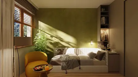Wnętrze w stylu japandi z zieloną ścianą, żółtym fotelem oraz rośliną.