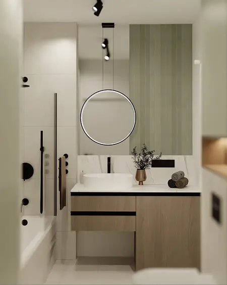Nowoczesna łazienka z drewnianą szafką, okrągłym lustrem i minimalistycznym designem.