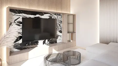 Wnętrze salonu w stylu japandi z minimalistycznym wystrojem i nowoczesnym telewizorem.