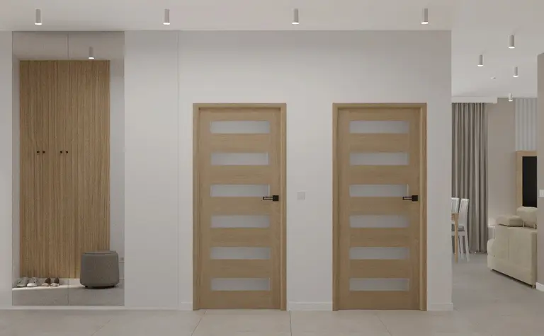 Przedpokój w stylu japandi z minimalistycznymi elementami i nowoczesnymi drzwiami.