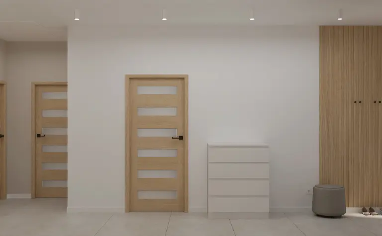 Przedpokój w stylu japandi, minimalistyczny z białą komodą i drewnianymi akcentami.