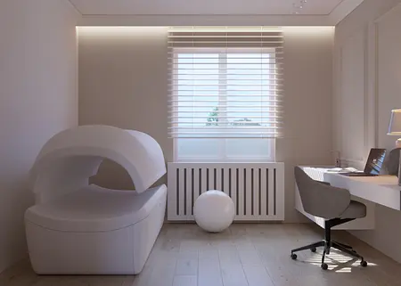 Wnętrze gabinetu z minimalistycznym biurkiem, szarym fotelem i nowoczesnym designem.