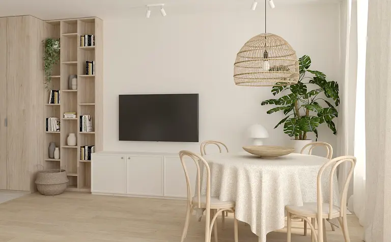 Salon w stylu boho i soft minimalizm z okrągłym stołem, rośliną i jasnymi meblami.