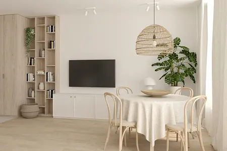Salon w stylu boho i soft minimalizm z okrągłym stołem, rośliną i jasnymi meblami.