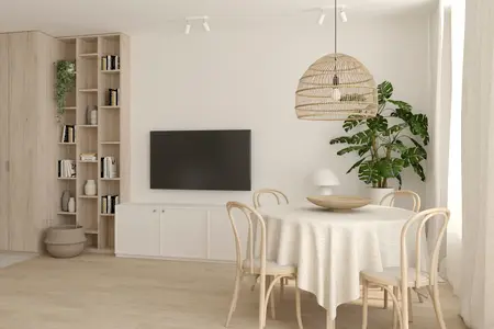 Salon w stylu boho i soft minimalizm z okrągłym stołem, rośliną i jasnymi meblami.