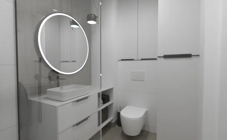 Nowoczesna łazienka z minimalistycznym designem, okrągłym lustrem, białymi meblami.