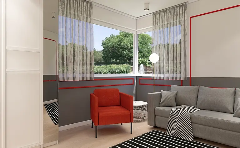 Wnętrze salonu w stylu minimalistycznym z szarymi meblami i czerwonym fotelem.