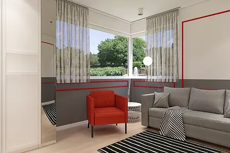 Wnętrze salonu w stylu minimalistycznym z szarymi meblami i czerwonym fotelem.