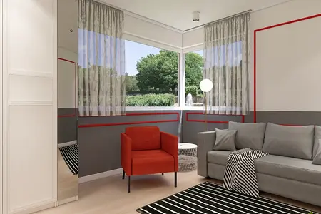 Wnętrze salonu w stylu minimalistycznym z szarymi meblami i czerwonym fotelem.