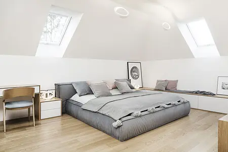 Wnętrze sypialni w stylu minimaluxe, nowoczesnym i quiet luxury z szarym łóżkiem.