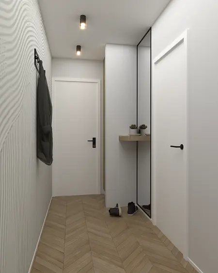 Nowoczesny przedpokój z minimalistycznymi akcentami i drewnianą podłogą.