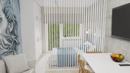 Sypialnia w stylu minimalistycznym z niebieską pościelą i białymi meblami