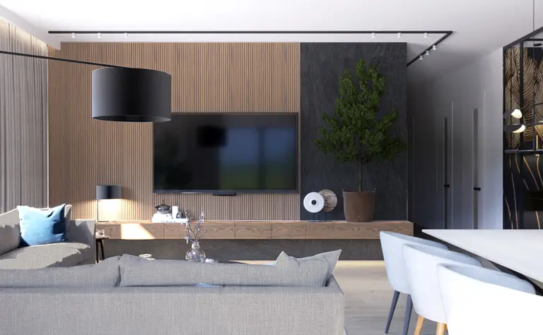 Wnętrze nowoczesnego salonu z drewnianą ścianą, telewizorem i rośliną.