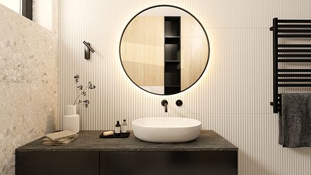 Nowoczesna łazienka z okrągłym lustrem, czarnymi i minimalistycznymi elementami.