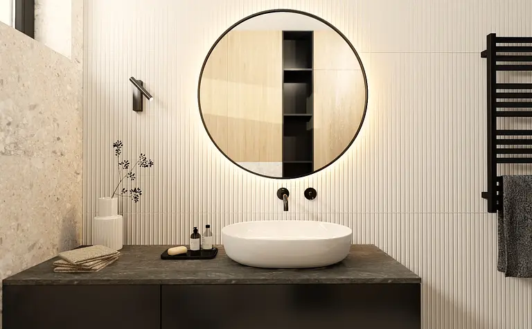 Nowoczesna łazienka z okrągłym lustrem, czarnymi i minimalistycznymi elementami.