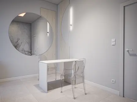 Minimalistyczne wnętrze z biurkiem, przezroczystymi krzesłami i dużym lustrem.