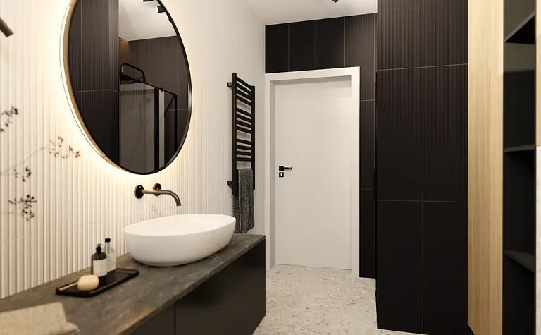 Nowoczesna łazienka z dużym okrągłym lustrem, minimalistycznymi meblami i industrialnym akcentem.