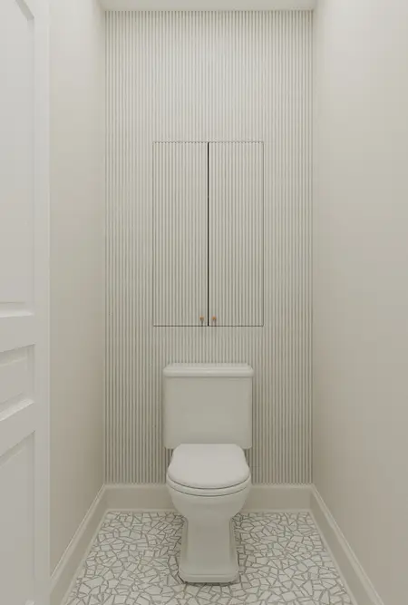 Toaleta w stylu art deco z białą ceramiką i mozaiką.