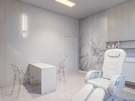 Wnętrze minimalistycznego gabinetu z białym fotelem oraz nowoczesnym biurkiem.