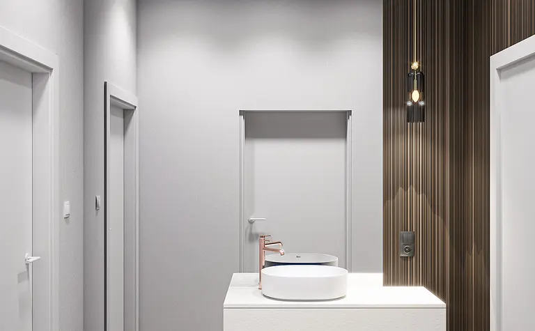 Minimalistyczna łazienka z białą umywalką i nowoczesnymi akcentami.