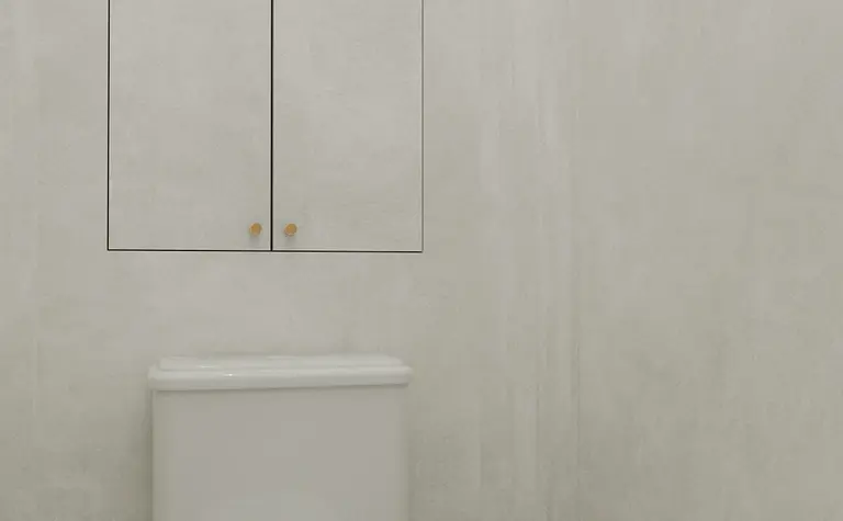 Toaleta z białą muszlą, szarymi ścianami i minimalistycznymi detalami art deco.