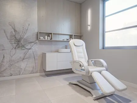 Nowoczesne wnętrze z białym fotelem i minimalistycznymi detalami.